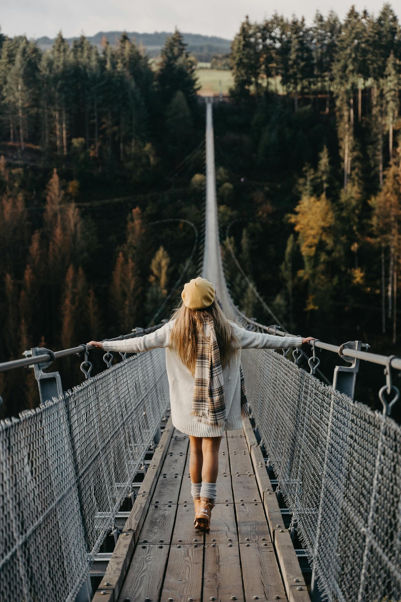 Woman Walking on a Suspension Bridge